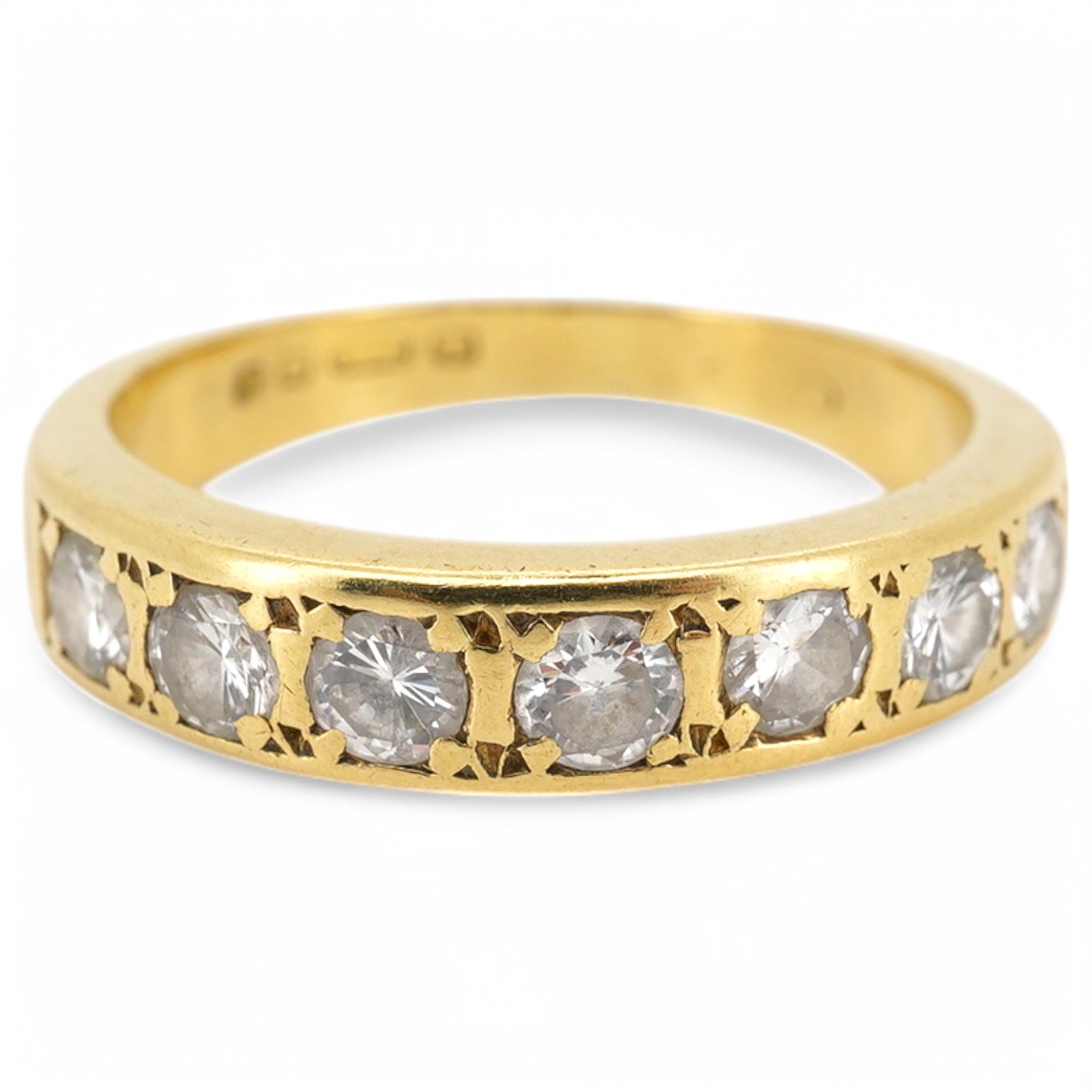 A modern 18ct gold and seven stone diamond set half hoop ring, size M, gross weight 4 grams.